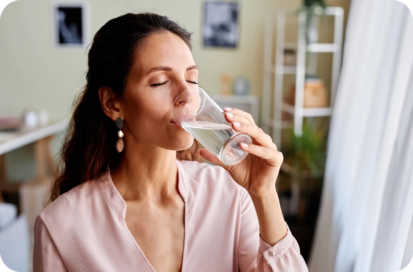 Woman drinking a glass of water in the morning