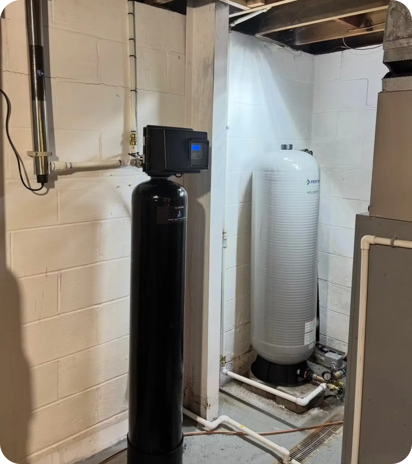 Whole-house iron and sulfur filtration system professionally installed by Cesare's Quality Water Solutions for private well water.