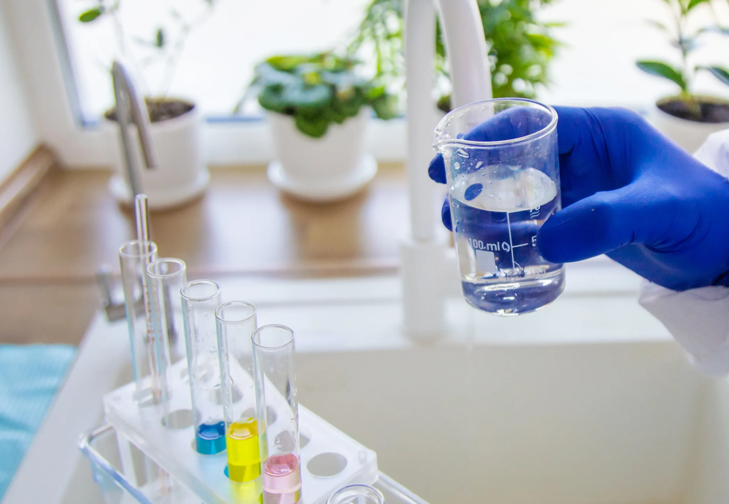 Water sample being collected from a residential faucet for professional laboratory water quality analysis.