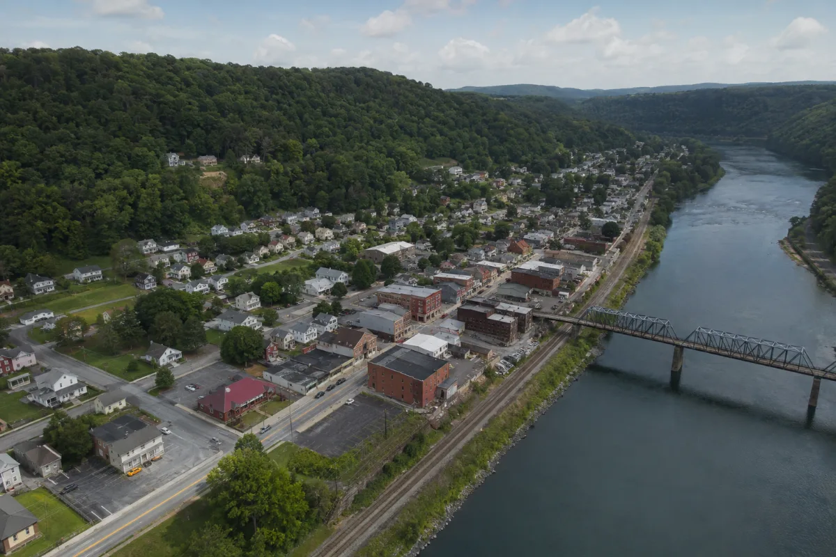 Aerial view of Blairsville, Pennsylvania along the Conemaugh River with the bridge, brick main street and wooded hillsides