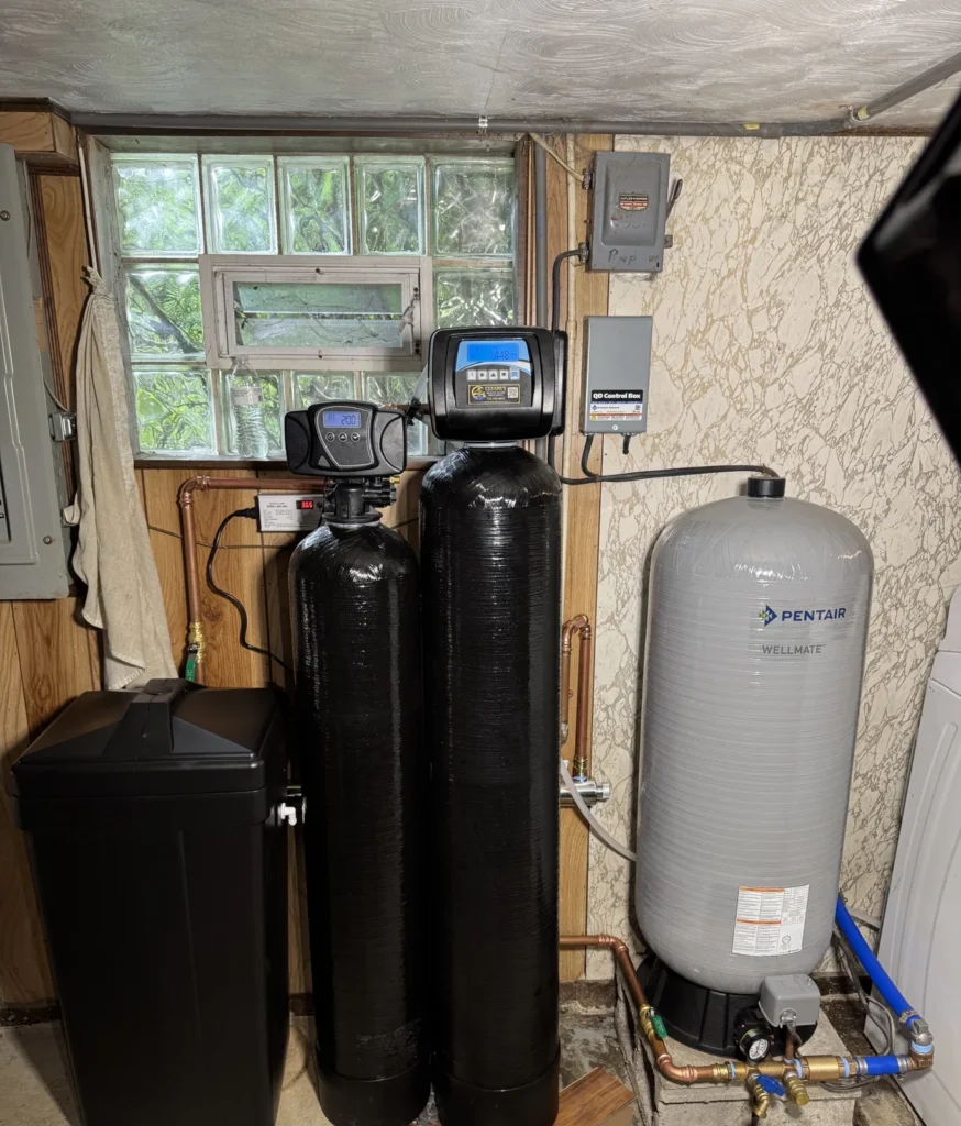 Cesare's private-well water treatment system with softener, filter and Pentair WellMate pressure tank in a Southwestern Pennsylvania basement