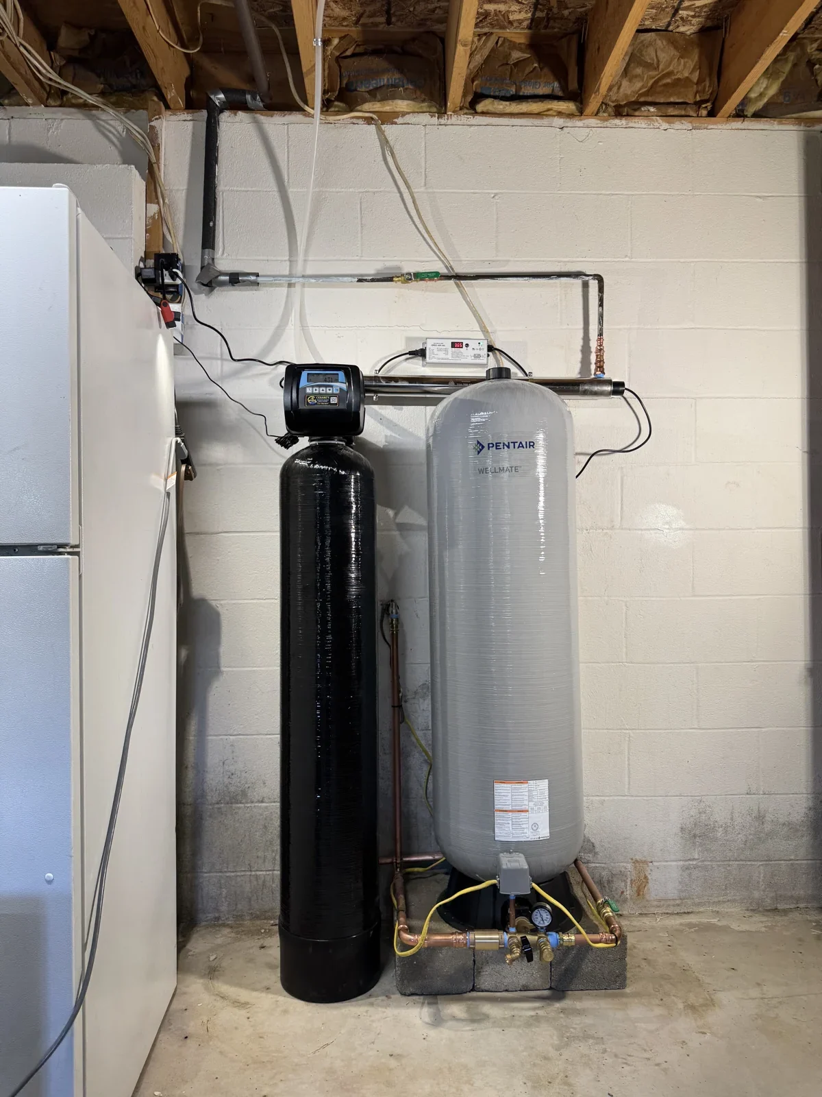Cesare's well-water treatment install with a Pentair WellMate pressure tank, whole-home filter and UV disinfection in a Southwestern Pennsylvania basement