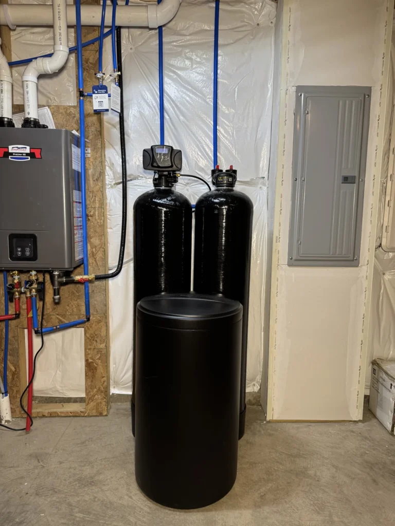 Cesare's whole-home twin softener and filter system with brine tank beside a tankless water heater in a Southwestern Pennsylvania home