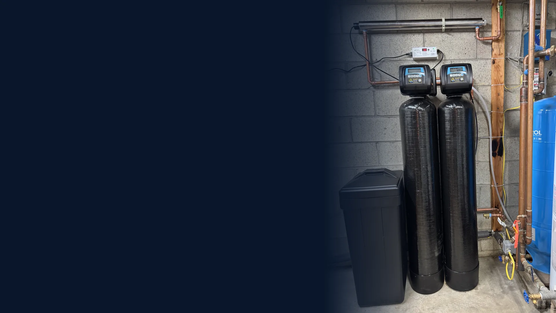 Cesare’s whole-house water treatment system with twin treatment tanks, brine tank, UV disinfection and well pressure tank installed in a Southwestern Pennsylvania basement